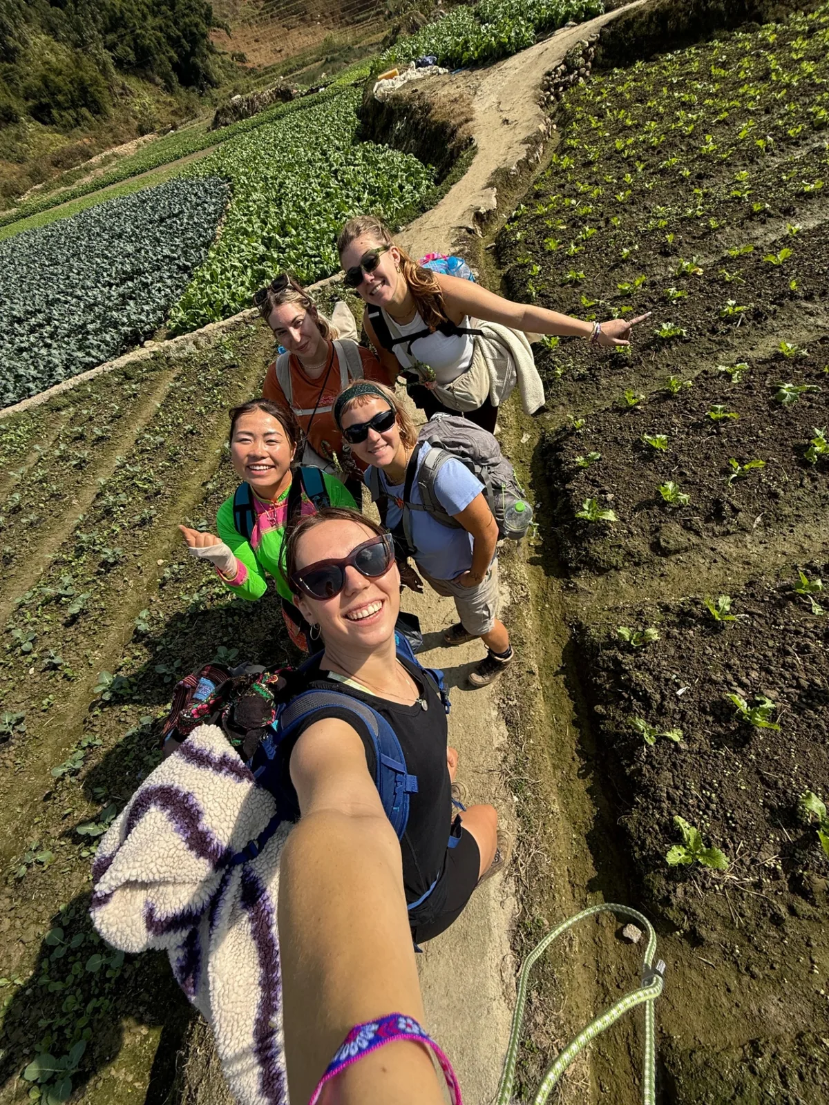 Nhu with a group of guests on a sunny Sapa trekking path